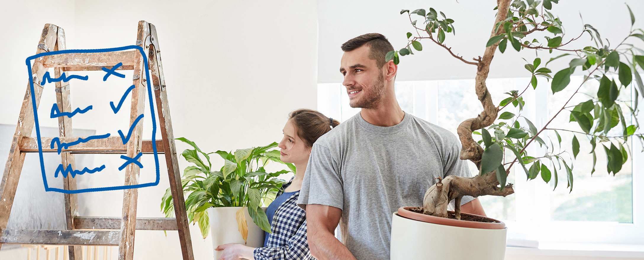 paar stellt pflanzen in neue wohnung